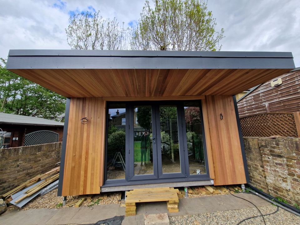 Deep cedar-lined canopy over four-panel glazing